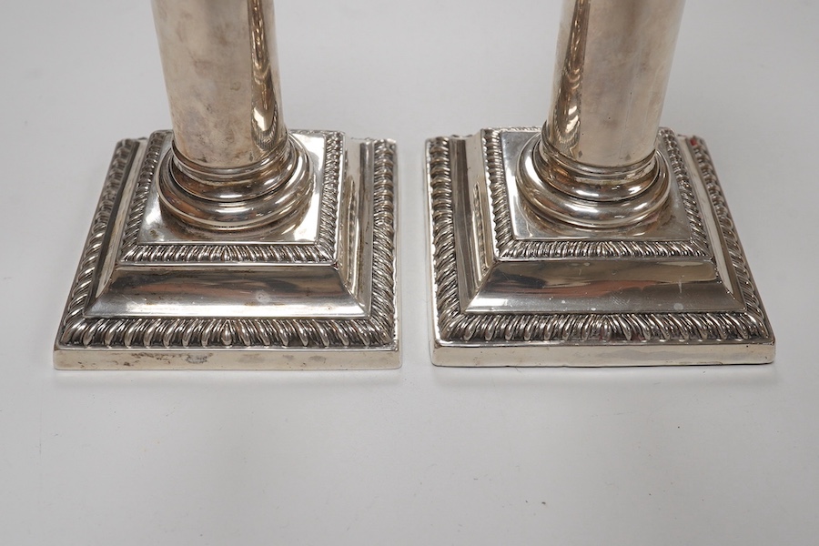 A pair of Edwardian silver dwarf candlesticks, by William Hutton & Sons, London, 1905, 14cm, weighted. Condition - fair